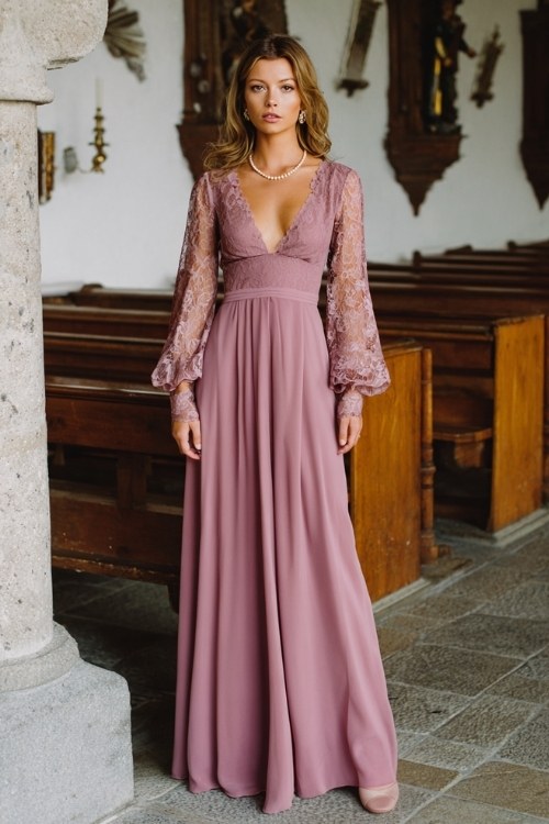 A woman wears a floor-length mauve gown with lace sleeves and a flattering empire waist