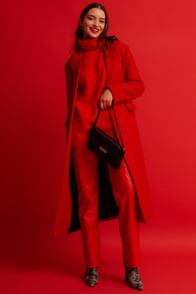 A woman wears cowboy boots with red formal outfit