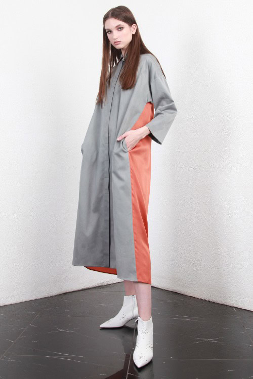 A woman wears cowboy boots with a stylish dress