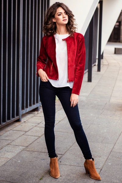 A woman wears jeans with brown suede boots, white t shirt and red coat