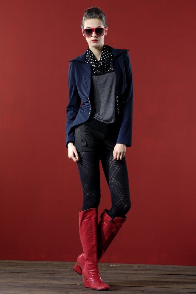 A cool girl wears red cowboy boots with tights, black shorts and a blazer