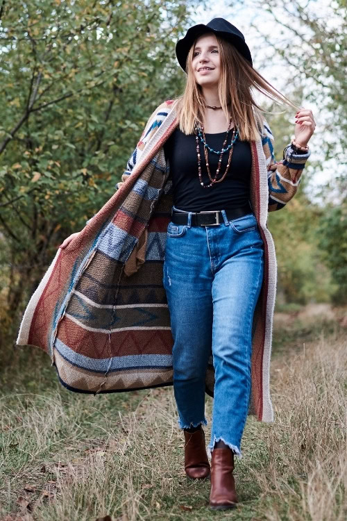 a woman wears brown cowboy boots with a black top and jeans