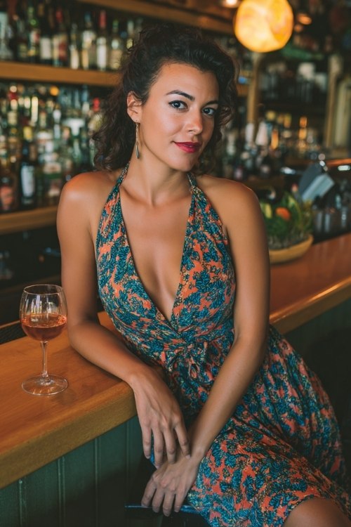 a woman wears a floral halter dress for going out at night in a bar
