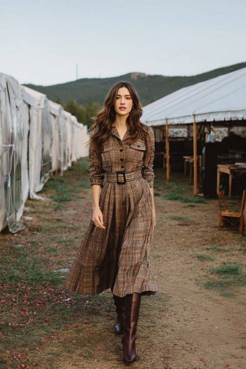 A woman wears a forest plaid A-line midi with a belted waist and soft pleats, paired with chocolate knee-high boots (3)