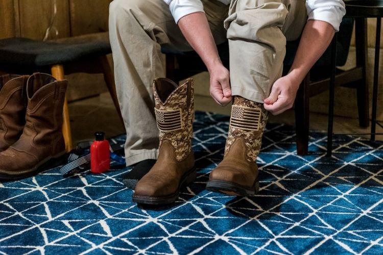 A man wear a pair of stockman cowboy boots