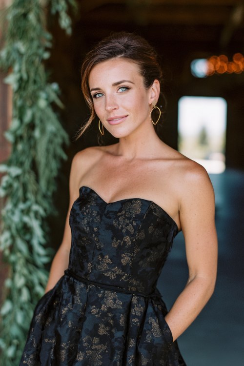 a woman in a black floral jacquard cocktail dress with structured bodice and flared skirt (2)