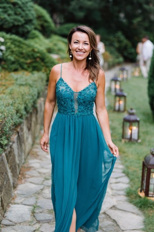 a woman over 50 in a teal chiffon cocktail dress with embroidered bodice