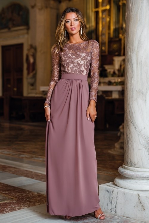 A woman wears a floor-length mauve gown with lace sleeves and a flattering empire waist