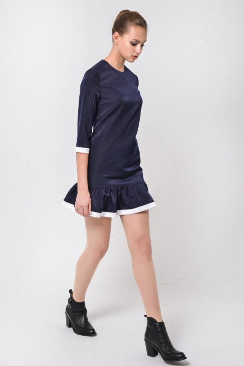 a woman wears black cowboy boots with a dark blue dress