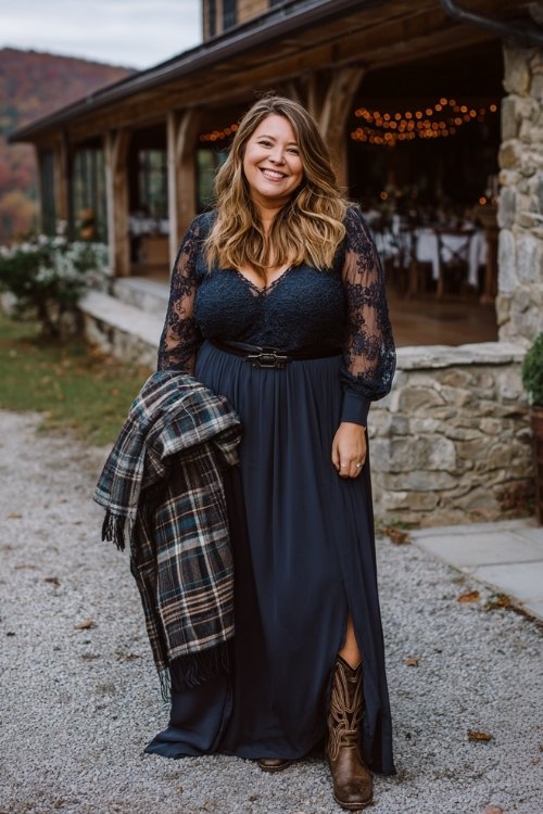 A plus-size woman in a navy gown with a sheer embroidered overlay and bishop sleeves, paired with distressed leather cowboy boots