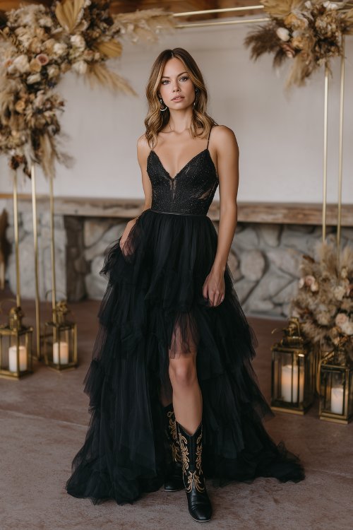 A woman in a black tulle gown with layers and subtle sparkle, paired with embroidered cowboy boots