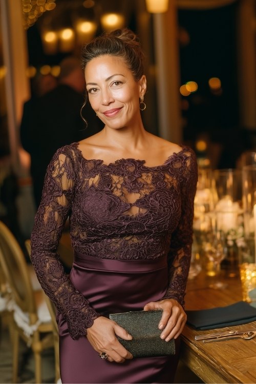 a woman over 50 in a dark plum long-sleeve gown with lace bodice