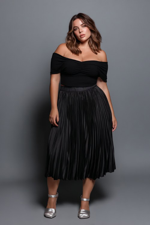 A plus-size woman wearing a fitted black off-shoulder top with a pleated midi skirt and metallic sandals, styled for a casually elegant summer going-out outfit