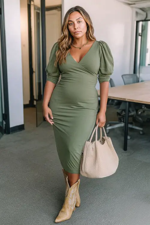 A curvy woman wears a structured midi dress in olive green with tan cowboy boots and a matching tote bag