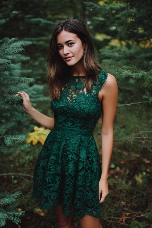a petite woman in a forest green lace dress with scalloped hem hitting just above the knee