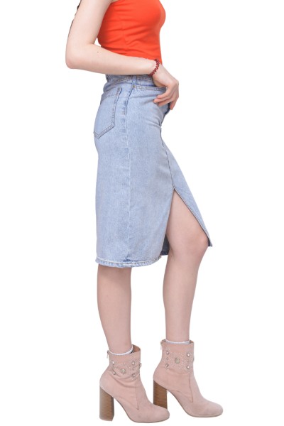 A woman wears denim skirt with ankle boots and orange top