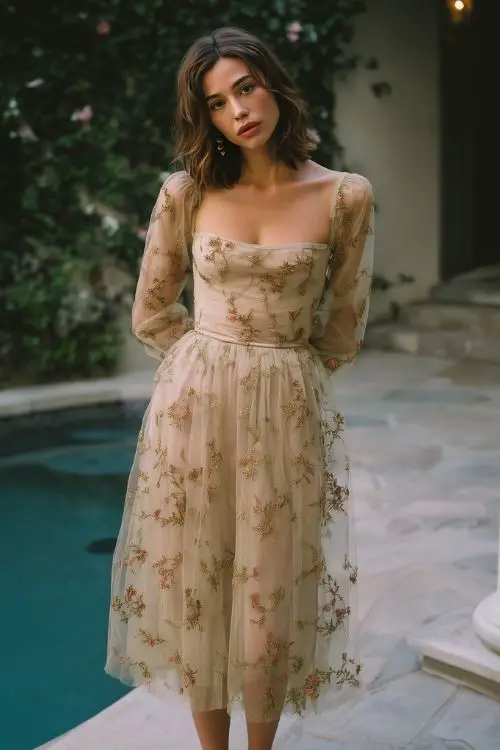 a woman wears a sheer floral embroidered wedding guest dress for outdoor fall wedding