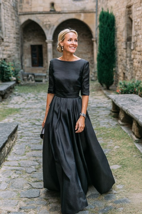 a woman over 50 in a charcoal brocade gown with bateau neckline, three-quarter sleeves