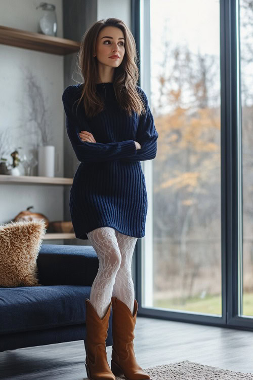 A woman wears a navy blue sweater dress, white patterned tights, and brown cowboy boots