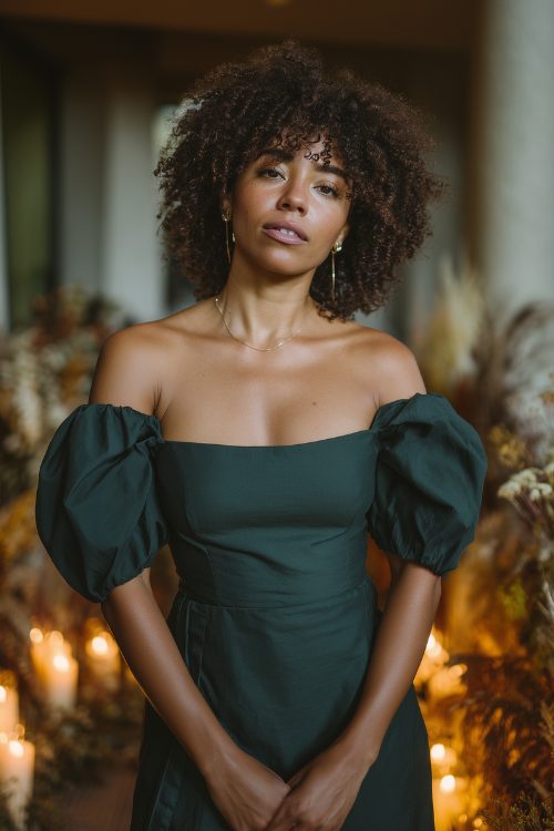 A black woman over 30 in a fitted forest green dress with puff sleeves and an asymmetric hem