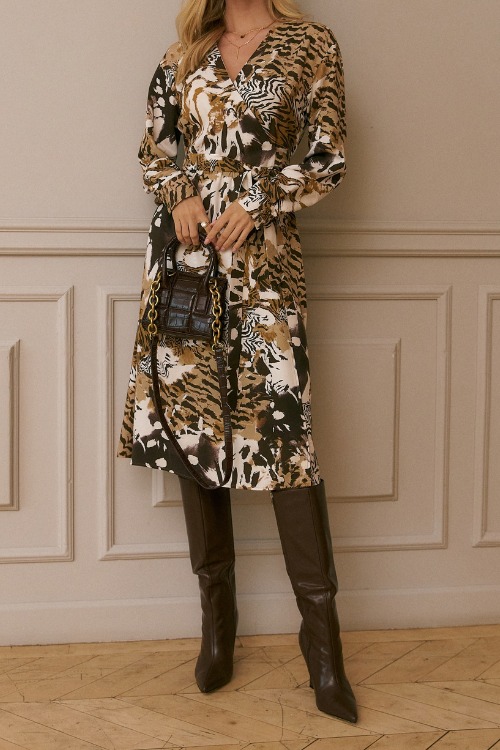 a woman wears cowboyboots with a textured wrap dress