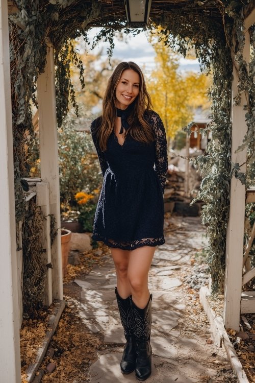 A woman over 30 in a navy long-sleeve mini dress with lace detailing and classic black cowboy boots (3)