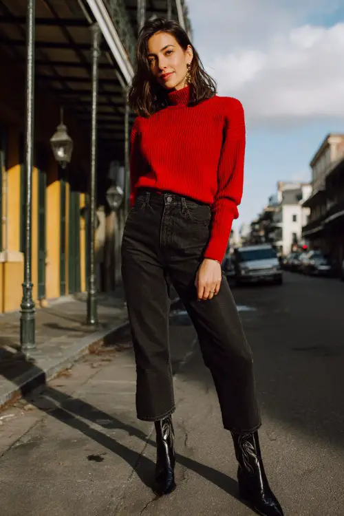 A woman over 30 wears a fitted red sweater with straight-leg dark denim and glossy black cowboy boots (2)