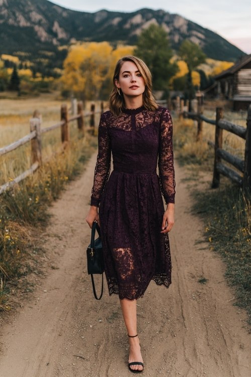 a petite woman in a deep plum lace midi dress with a scalloped hem and sheer sleeves