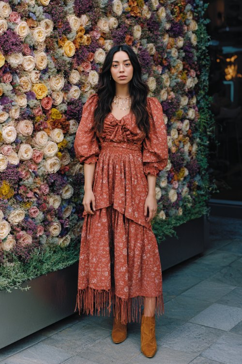 A woman wears a terracotta floral smocked midi with peasant sleeves and a tiered skirt (2)