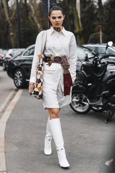 A cool girl wears white cowboy boots with white outfit