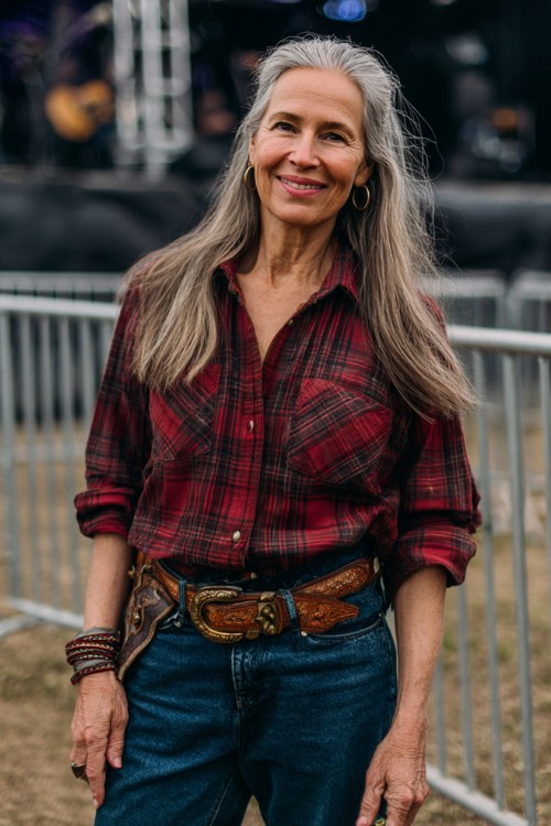 A woman over 40 wears classic indigo jeans with a deep red flannel tucked in